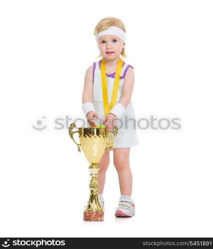 Portrait of baby in tennis clothes with medal and goblet