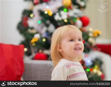 Portrait of baby near Christmas tree