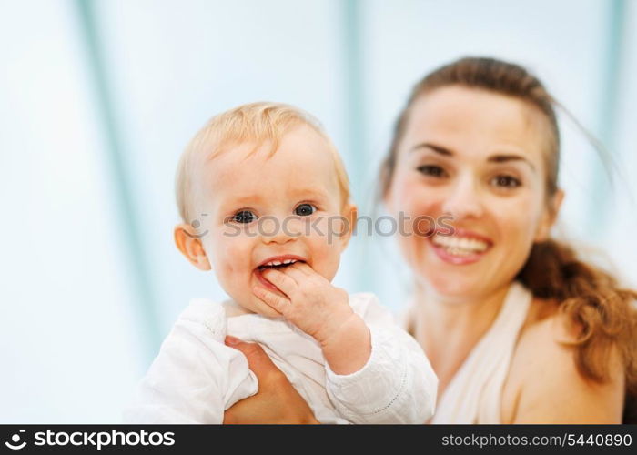 Portrait of baby playing with mother