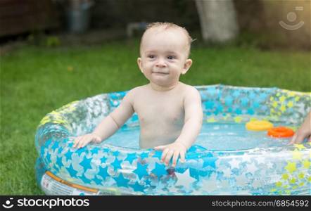 Portrait of baby relaxing in pool at garden