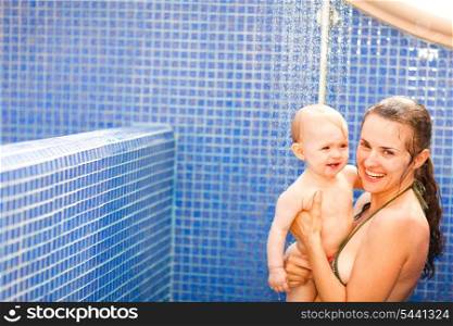 Portrait of baby with mom taking shower&#xA;