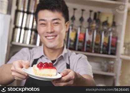 Portrait of barista serving cheesecake