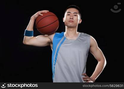 Portrait of basketball player, black background