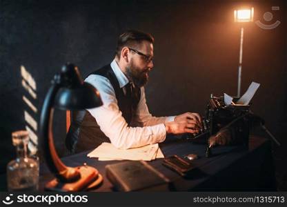 Portrait of bearded literature author in glasses typing on vintage typewriter. Creative people concept. Literature author in glasses typing on typewriter