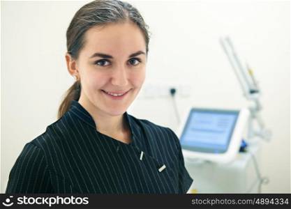 Portrait Of Beautician Standing By Laser Treatment Equipment