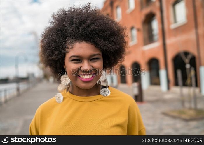 Portrait of beautiful afro american latin confident woman in the street. Urban concept.