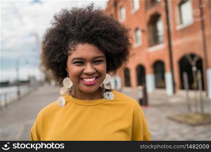 Portrait of beautiful afro american latin confident woman in the street. Urban concept.