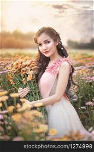 portrait of beautiful asian woman in nature flowers field