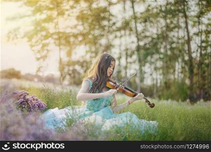 portrait of beautiful asian woman in nature flowers field with violine. portrait of beautiful asian woman in nature flowers field