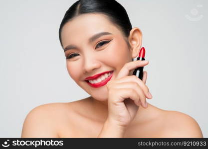 Portrait of Beautiful Asian woman with lipstick in hand. Skin care healthy hair and skin close up face beauty isolated over background. Cosmetology and Spa concept.