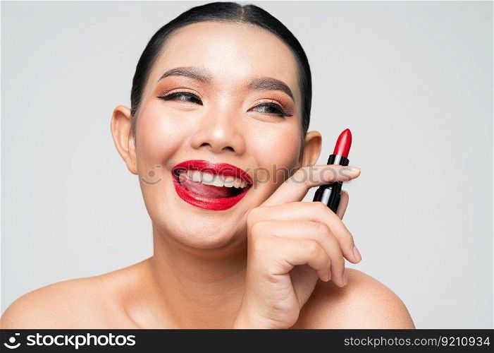 Portrait of Beautiful Asian woman with lipstick in hand. Skin care healthy hair and skin close up face beauty isolated over background. Cosmetology and Spa concept.