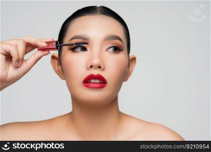 Portrait of Beautiful Asian woman with mascara in hand. Skin care healthy hair and skin close up face beauty isolated over background. Cosmetology and Spa concept.