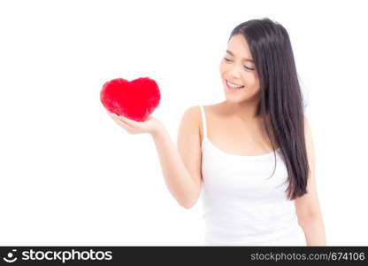 Portrait of beautiful asian young woman holding red heart shape pillow and smile isolated on white background, valentines day, holiday concept.