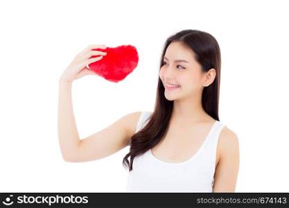 Portrait of beautiful asian young woman holding red heart shape pillow and smile isolated on white background, valentines day, holiday concept.