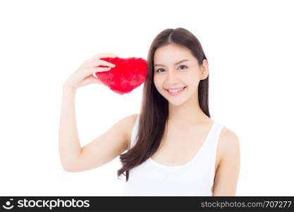 Portrait of beautiful asian young woman holding red heart shape pillow and smile isolated on white background, valentines day, holiday concept.