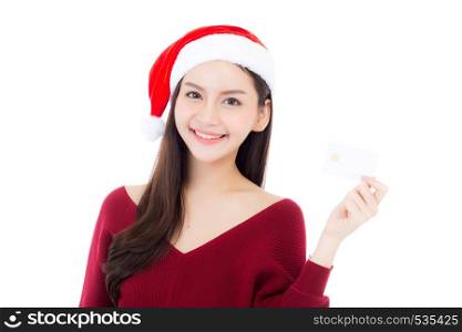 Portrait of beautiful asian young woman in santa hat smile holding credit card, girl have happy with shopping isolated on white background, christmas and holiday concept.