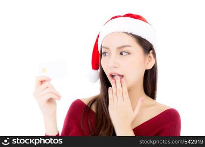 Portrait of beautiful asian young woman in santa hat smile holding credit card, girl have happy with shopping isolated on white background, christmas and holiday concept.