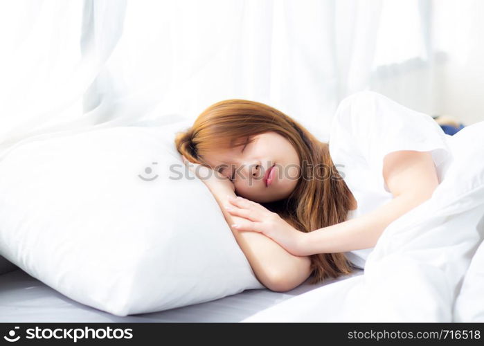 Portrait of beautiful asian young woman sleep lying in bed with head on pillow comfortable and happy with leisure, girl with relax for health and lifestyle concept.