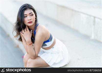 Portrait of beautiful athletic young asian woman in fashionable sportswear standing and having rest after strong exercise training in garden the park,Outdoor Sporty concept