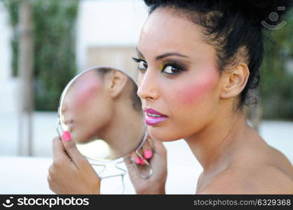 Portrait of beautiful black girl with mirror