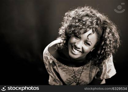 Portrait of beautiful black woman on black background. Studio shot