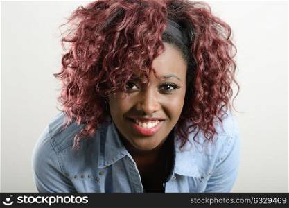 Portrait of beautiful black woman on white background wearing casual clothes. Red hairstyle Studio shot