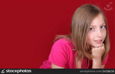 Portrait of beautiful blond girl on red background