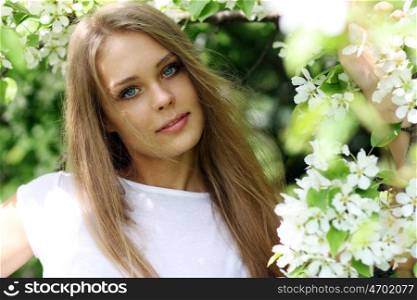 Portrait of beautiful blond in spring blossom