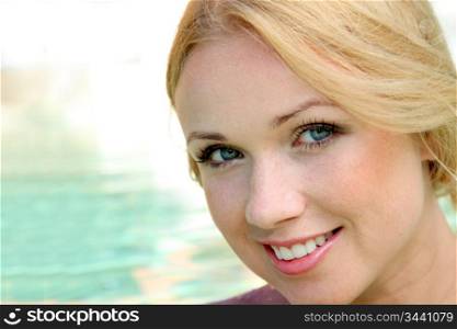 Portrait of beautiful blond woman in swimming pool