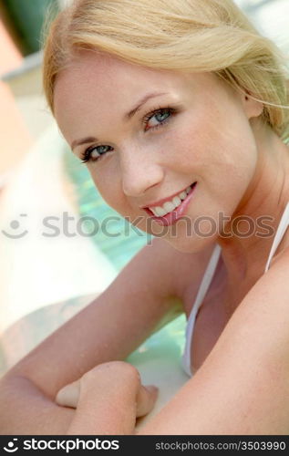 Portrait of beautiful blond woman in swimming pool