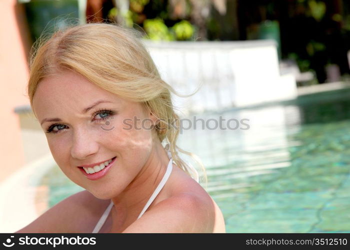 Portrait of beautiful blond woman in swimming pool