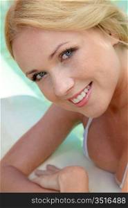 Portrait of beautiful blond woman in swimming pool