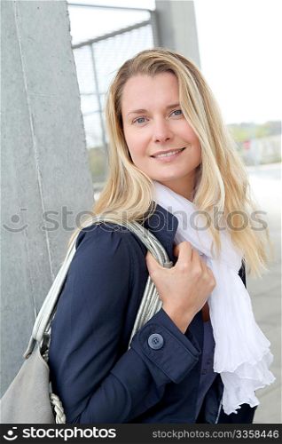 Portrait of beautiful blond woman in town