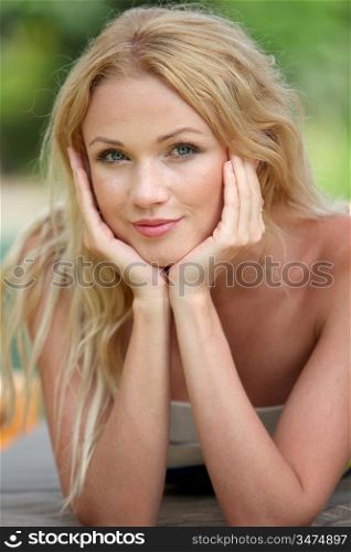 Portrait of beautiful blond woman relaxing in garden
