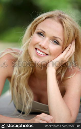 Portrait of beautiful blond woman relaxing in garden