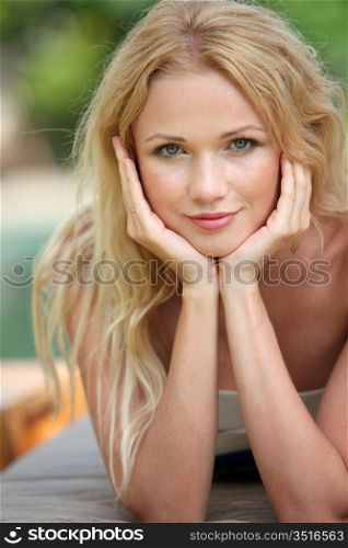 Portrait of beautiful blond woman relaxing in garden