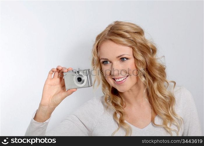Portrait of beautiful blond woman taking picture