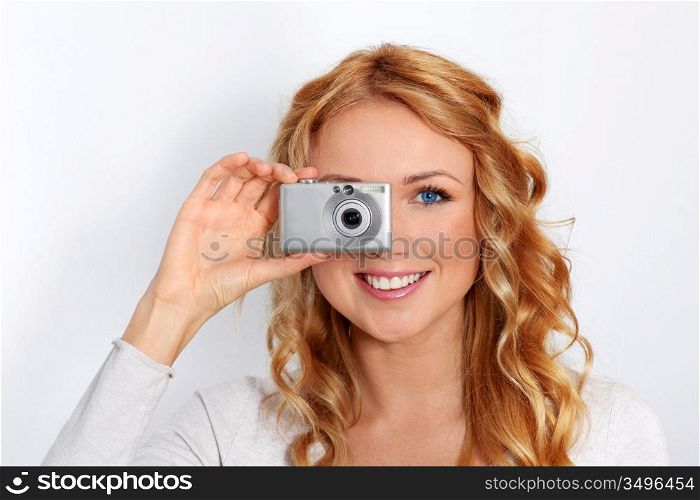 Portrait of beautiful blond woman taking picture