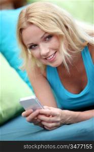 Portrait of beautiful blond woman using cellphone