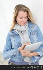 Portrait of beautiful blond woman using electronic tablet