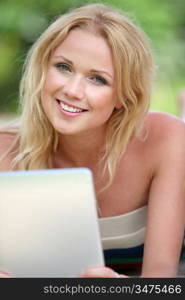 Portrait of beautiful blond woman using electronic tablet