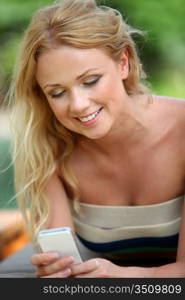 Portrait of beautiful blond woman using mobile phone