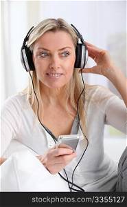 Portrait of beautiful blond woman with headphones on