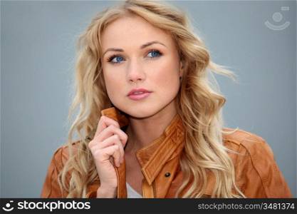 Portrait of beautiful blond woman with leather jacket