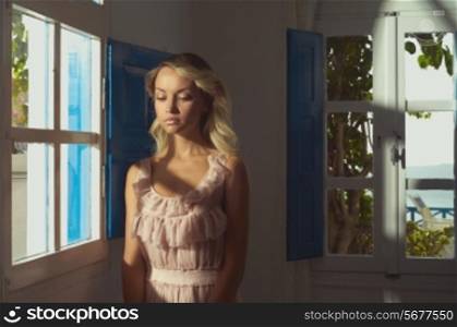 Portrait of beautiful blonde princess in stained window