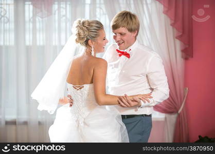 Portrait of beautiful bride and groom dancing at restaurant