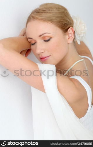 Portrait of beautiful bride on white background with eyes shut