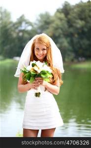 Portrait of beautiful bride with flowers