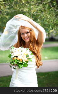 Portrait of beautiful bride with flowers