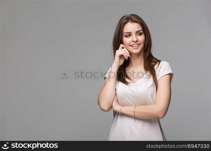 Portrait of beautiful brunette woman with natural make-up, on grey background. Portrait of beautiful brunette woman with natural make-up, on grey background.